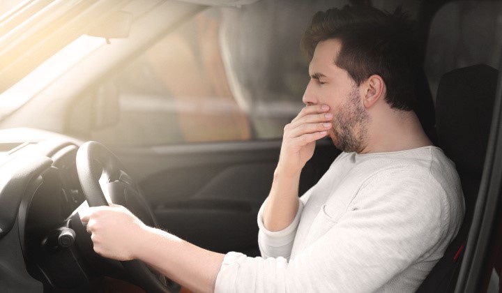 Gähnender Autofahrer Autofahrer mit Schlafproblemen gähnt